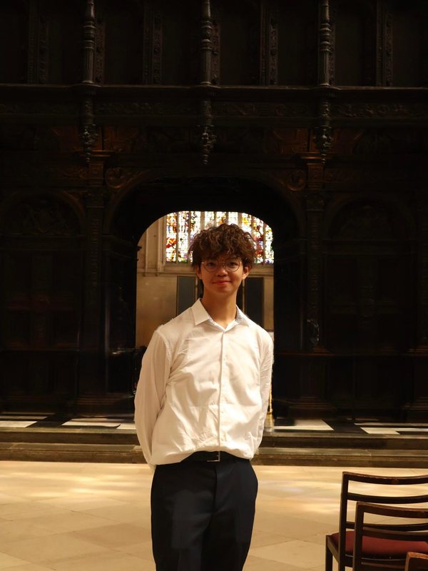 Owen, founder of O8EN Trading, standing in a chapel