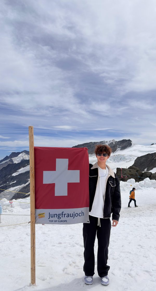 Owen holding a Swiss flag on the Jungfraujoch in the Alps